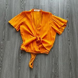 ASTR orange tie, front bodysuit size small